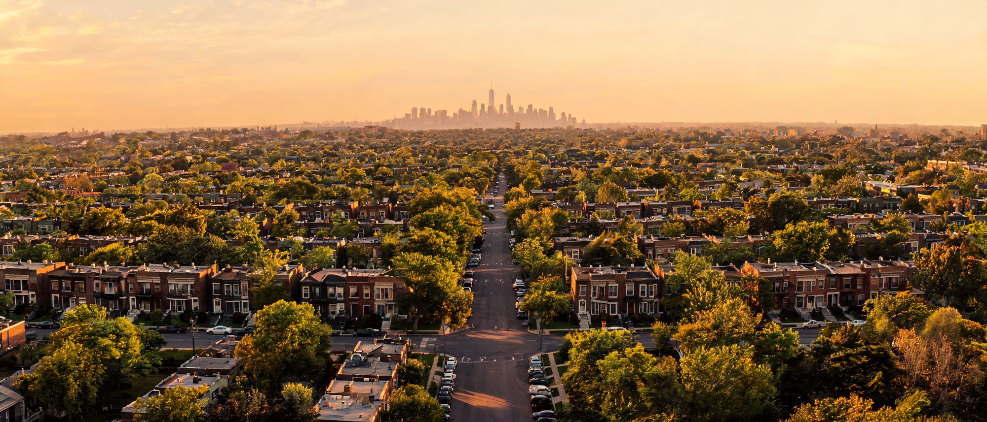 Aerial view of Queens, New York at golden hour with the Manhattan skyline